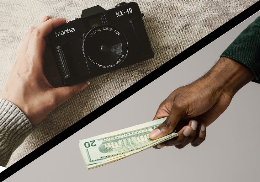 A hand is holding a camera and a hand is holding money.
