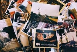 A pile of old photos on a table.