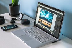 a laptop computer sitting on top of a white desk.