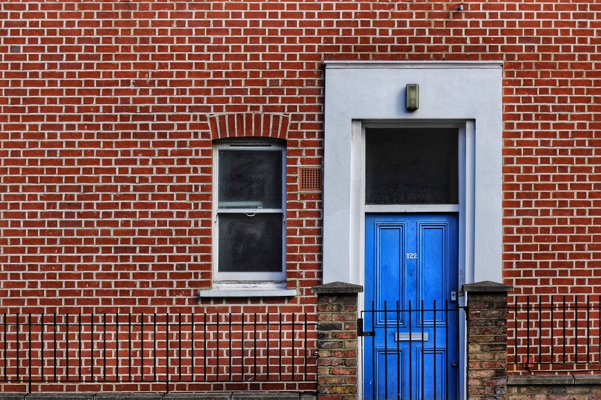 A blue door and brick building.