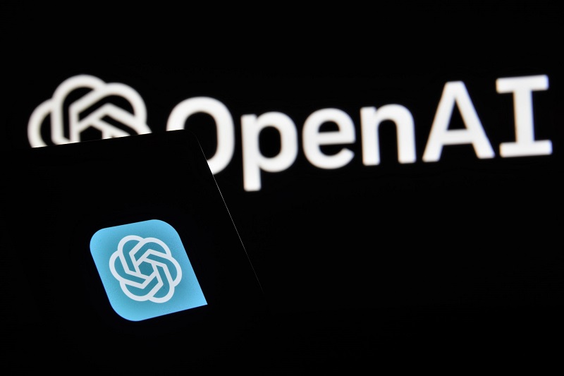 An open ai logo is shown in front of a phone.