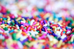 A close up of a pile of colorful sprinkles.