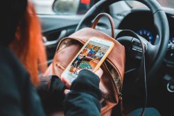 a person holding a cell phone in a car.